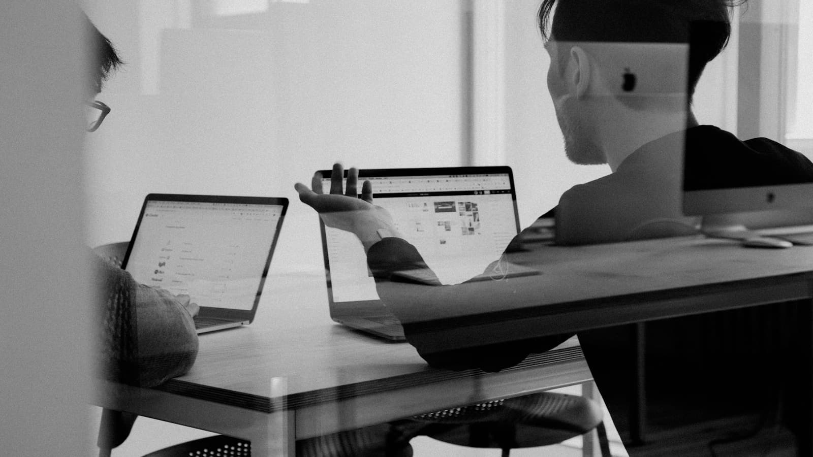 Two people collaborating on product strategy at a workspace