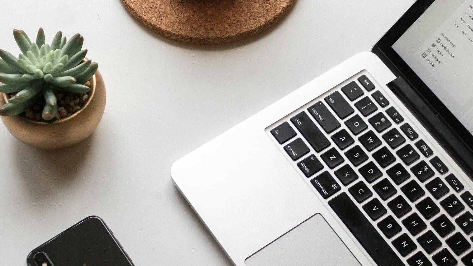 Laptop and phone on desk - reviewing audience feedback